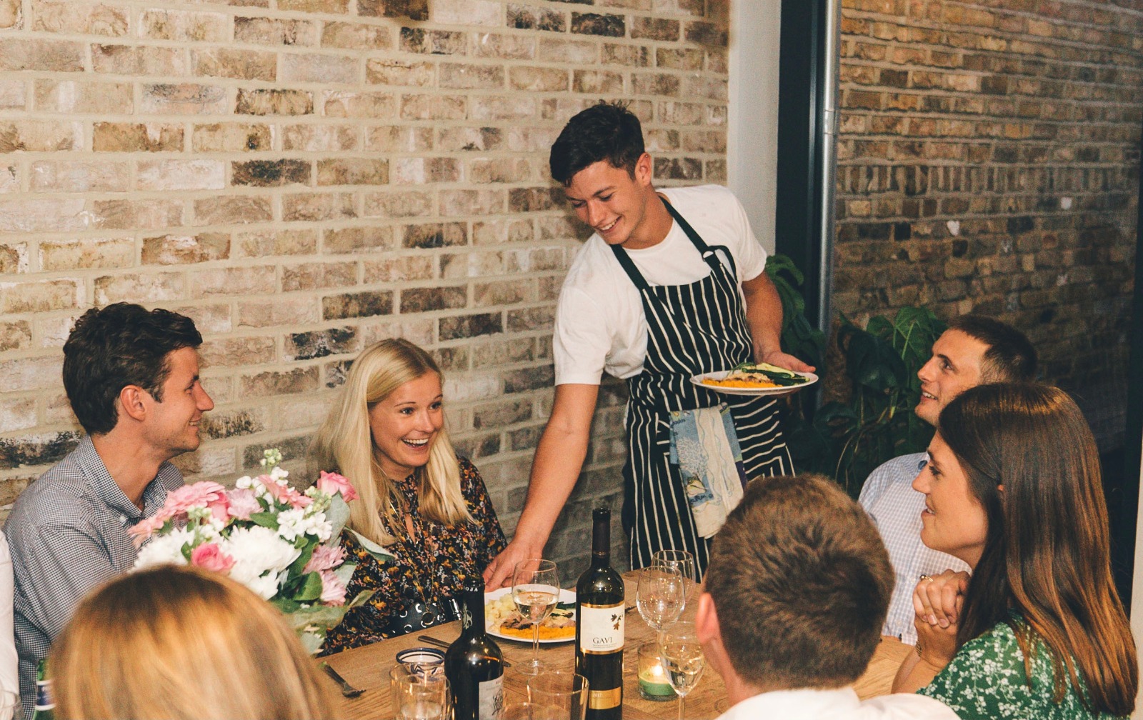 chef serving table of people
